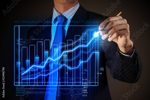 Photo: Business man drawing graphics Business man drawing graphics