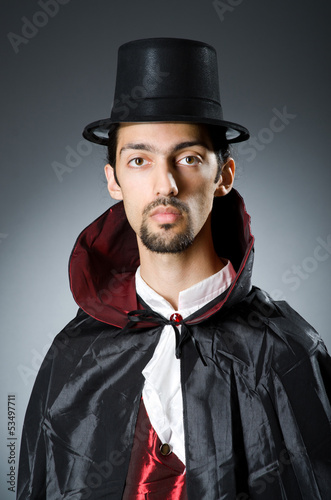 Photo: Magician in the dark room with wand Magician in the dark room with wand