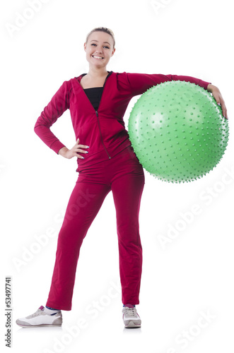 Photo: Young woman with ball exercising on whitee Young woman with ball exercising on whitee