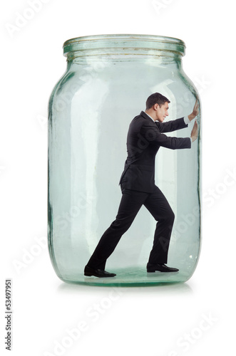 Photo: Young businessman in glass jar Young businessman in glass jar