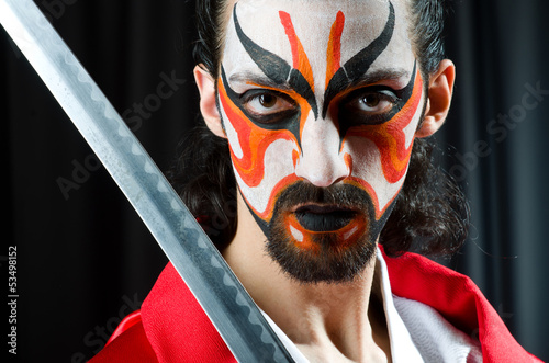 Photo: Man with sword and face mask Man with sword and face mask