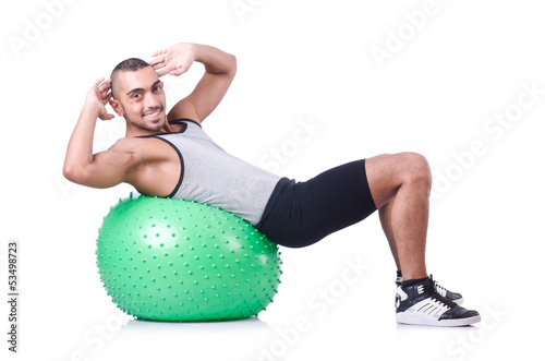 Photo: Man with swiss ball doing exercises on white Man with swiss ball doing exercises on white