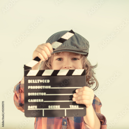 Photo: Kid holding clapper board in hands Kid holding clapper board in hands