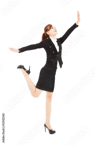 Photo: happy businesswoman jumping and try to reach something happy businesswoman jumping and try to reach something