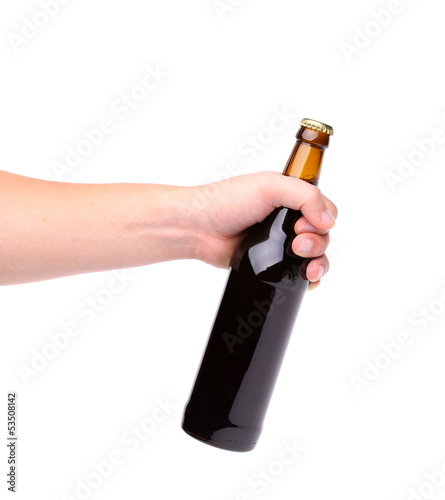 Photo: Beer bottle in the hand isolated on white Beer bottle in the hand isolated on white