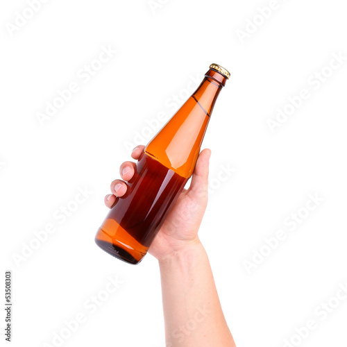 Photo: Beer bottle in the hand isolated on white Beer bottle in the hand isolated on white