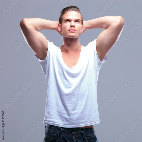 Photo: fashion man with hands behind head fashion man with hands behind head