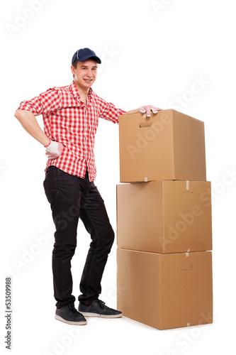 Photo: Handsome young courier with brown boxes Handsome young courier with brown boxes