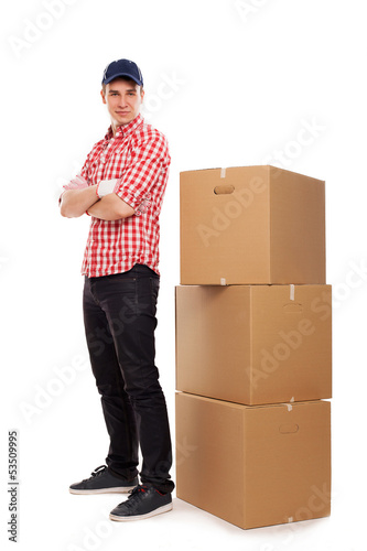 Photo: Handsome young courier with brown boxes Handsome young courier with brown boxes