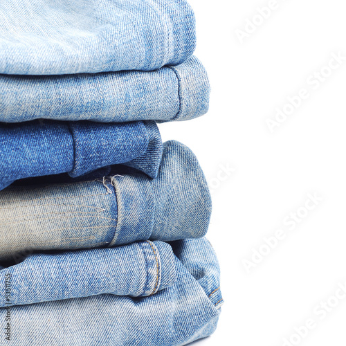 Photo: Stack of blue jeans on white background Stack of blue jeans on white background