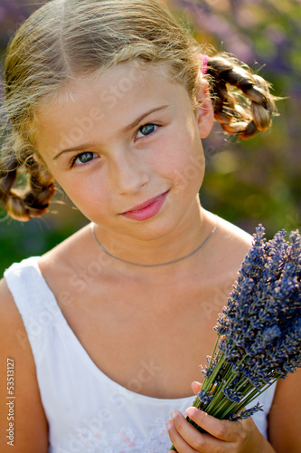 Photo: Portrait of lovely girl with bunch of lavender flowers Portrait of lovely girl with bunch of lavender flowers