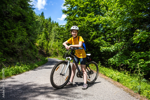 Photo: Healthy lifestyle - teenage girl biking Healthy lifestyle - teenage girl biking