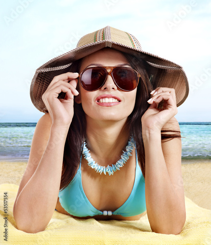 Photo: Girl in bikini drinking alcohol coctail through a straw. Girl in bikini drinking alcohol coctail through a straw.