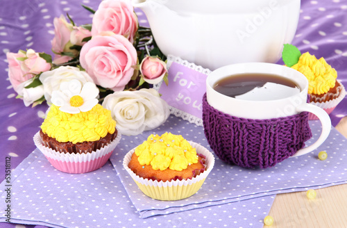 Photo: Delicious beautiful cupcakes on dining table close-up Delicious beautiful cupcakes on dining table close-up