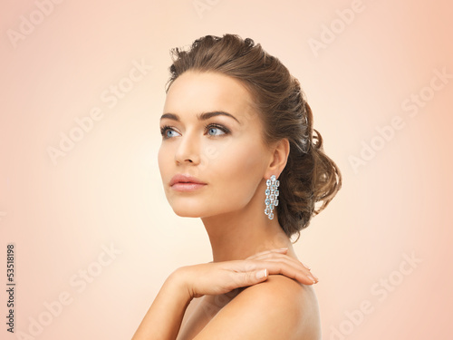 Photo: woman wearing shiny diamond earrings woman wearing shiny diamond earrings