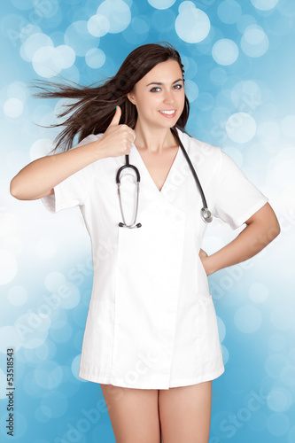 Photo: attractive female doctor woman show thumbs up hand sign attractive female doctor woman show thumbs up hand sign