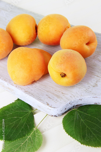 Photo: Apricots on board on wooden table Apricots on board on wooden table