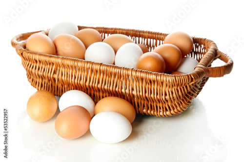 Photo: Many eggs in basket isolated on white Many eggs in basket isolated on white