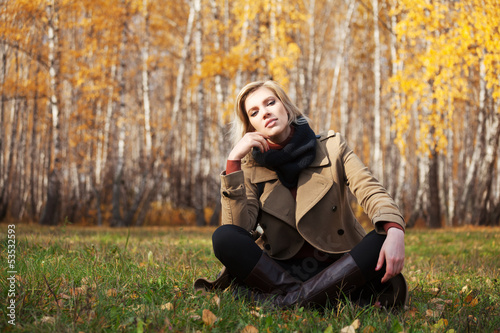 Photo: Happy blond woman in autumn forest Happy blond woman in autumn forest