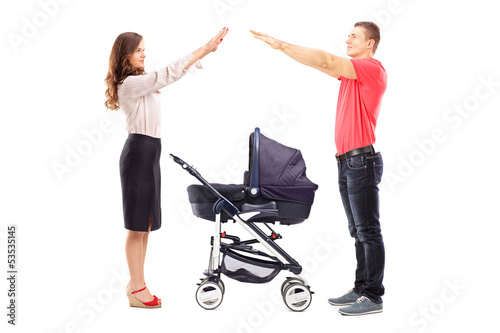 Photo: Mother and father gesturing with their hands protection Mother and father gesturing with their hands protection