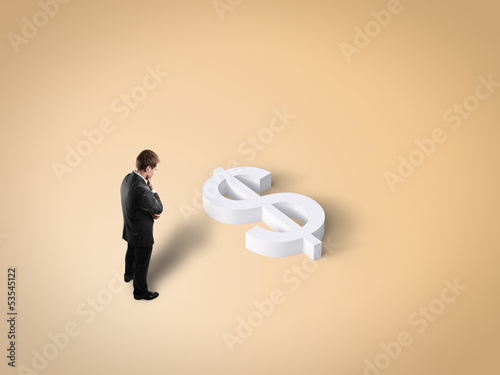 Photo: man and toy dollar sign man and toy dollar sign