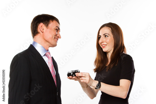 Photo: young man and woman are holding a toy car young man and woman are holding a toy car