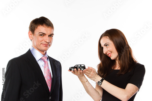 Photo: young man and woman are holding a toy car young man and woman are holding a toy car