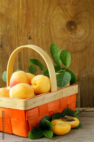 Photo: yellow sweet ripe apricots (peaches) with green leaves yellow sweet ripe apricots (peaches) with green leaves
