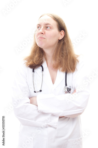 Photo: Young female physician cross-armed thinking about something Young female physician cross-armed thinking about something