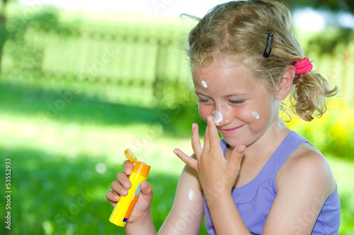Photo: smiling girl with suncream smiling girl with suncream