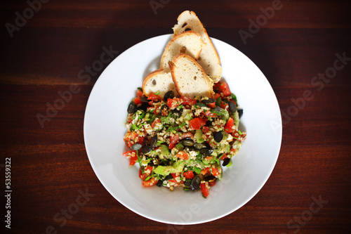 Photo: Tabbouleh salad with bulgur wheat, tomatoes, olives and crackers Tabbouleh salad with bulgur wheat, tomatoes, olives and crackers