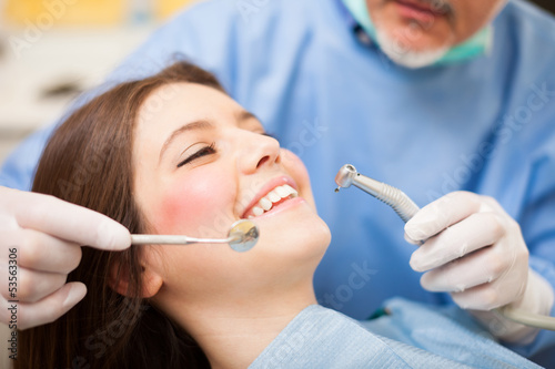 Photo: Dentist doing a treatment Dentist doing a treatment