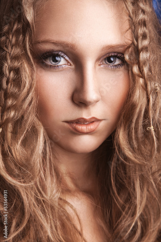 Photo: Portrait of charming young woman with curly brown hair Portrait of charming young woman with curly brown hair
