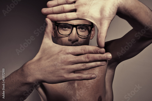 Photo: Portrait of man making a square by hands Portrait of man making a square by hands