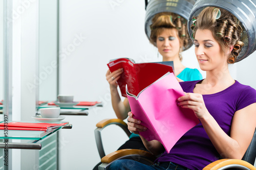 Photo: Women at the hairdresser with hair dryer Women at the hairdresser with hair dryer