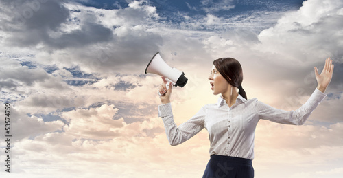 Photo: Businesswoman screaming in megaphone Businesswoman screaming in megaphone