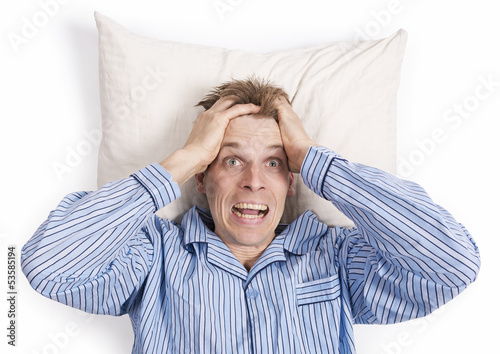 Photo: Stressed man in bed with hands in hair Stressed man in bed with hands in hair