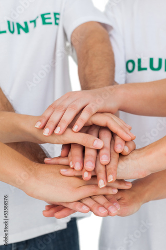 Photo: Volunteers putting hands together Volunteers putting hands together
