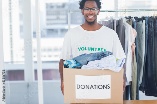 Photo: Attractive man holding a donation box Attractive man holding a donation box