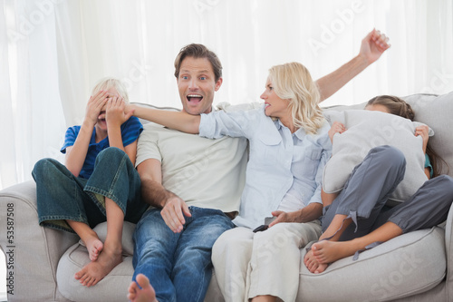 Photo: Mother hiding the face of her son while watching a horror movie Mother hiding the face of her son while watching a horror movie