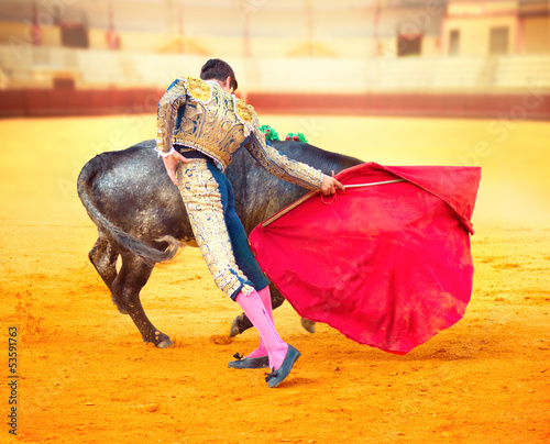Photo: Corrida. Matador Fighting in a typical Spanish Bullfight Corrida. Matador Fighting in a typical Spanish Bullfight