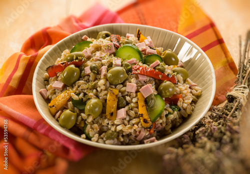 Photo: spelt sald with vegetables and ham, selective focus spelt sald with vegetables and ham, selective focus