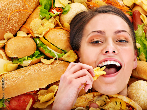 Photo: Woman eating hot dog. Woman eating hot dog.