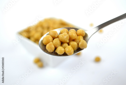 Photo: Chickpeas in small white dish with spoon Chickpeas in small white dish with spoon