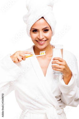 Photo: young woman brushing teeth young woman brushing teeth
