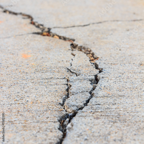 Photo: close up of crack cement road close up of crack cement road