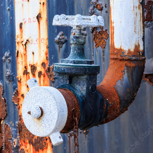 Photo: rusty water valve and tank rusty water valve and tank