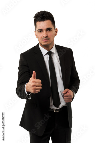 Photo: Handsome young businessman showing the thumbs up sign Handsome young businessman showing the thumbs up sign