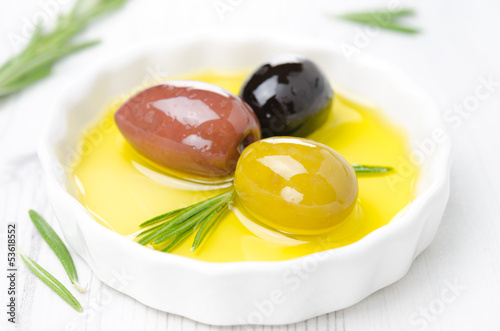 Photo: three kinds of olives and rosemary in bowl three kinds of olives and rosemary in bowl