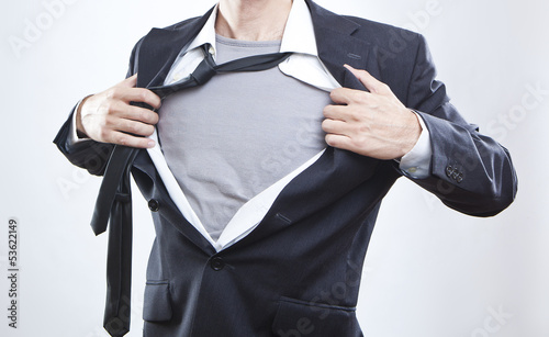 Photo: Closeup of a businessman showing the superhero suit under his sh Closeup of a businessman showing the superhero suit under his sh